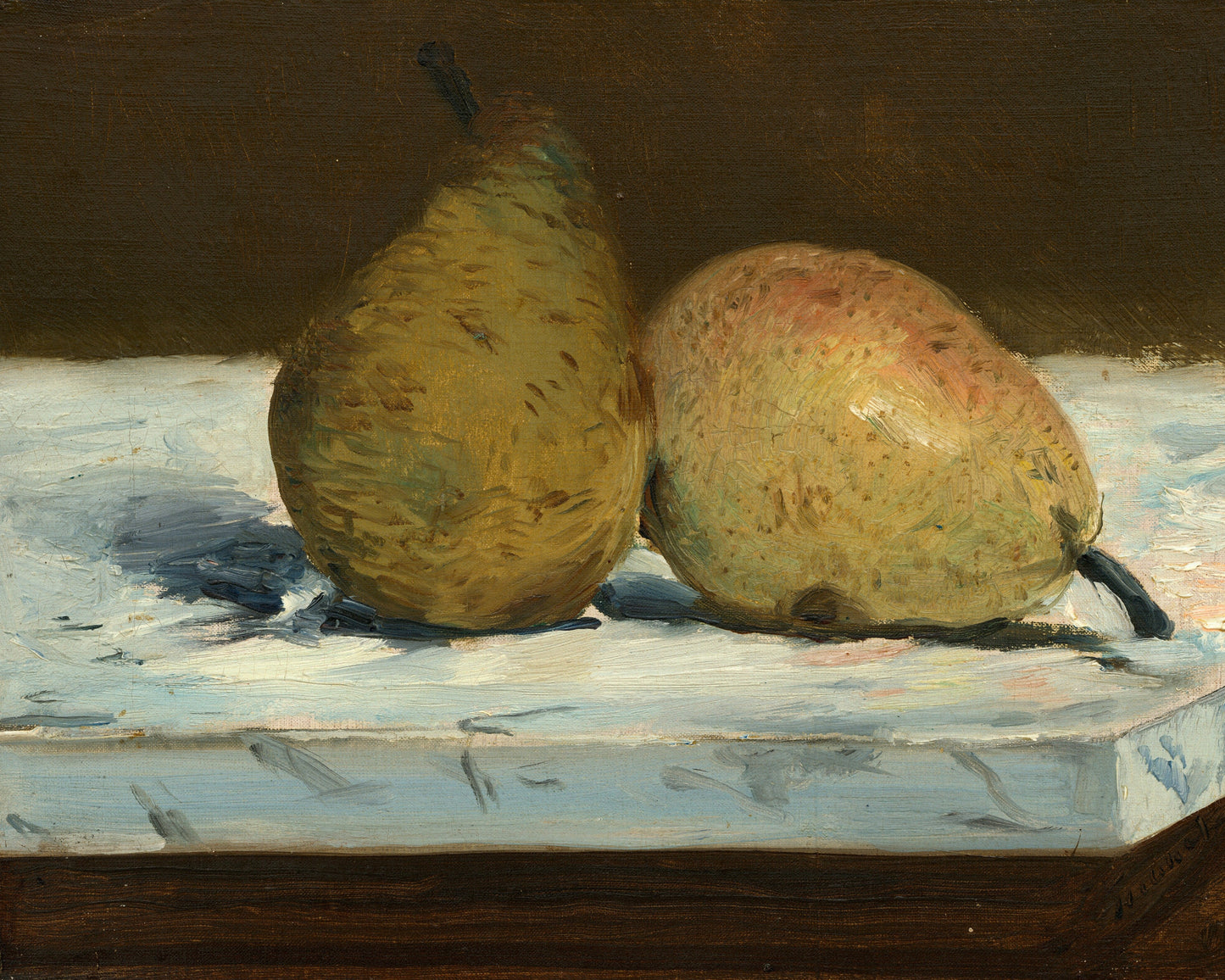 Two pears on a table with a dark background