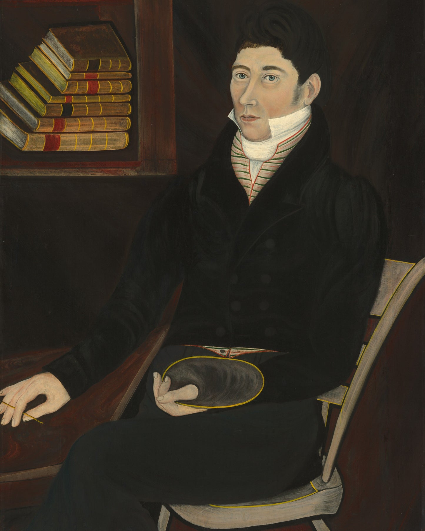 Portrait of a man in formal attire sitting in a chair with books on a shelf in the background.