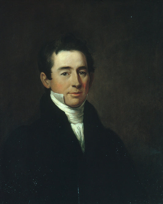 Portrait of a man in formal attire against a dark background
